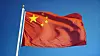 China flag waving against clean blue sky, close up, isolated wit