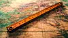 A ruler lying across a map, indicating measurement for a travel route or geographical survey