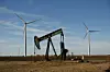 Wind power technology and oil well pump jack in rural West Texas / USA.