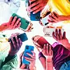 Teens in circle holding smart mobile phones - Multicultural youn