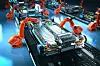 Robot assembly line with electric car battery cells module on pl