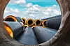 Insulated pipe. Large metal pipes with a plastic sheath at a construction site. Modern pipeline for supplying hot water and heating to a residential area. Close-up.
