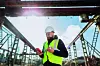 Construction engineer using smartphone at concrete production plant