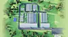 3D-Plan eines Industriekomplexes mit Hallen, Straßen und Solarfeldern in Landschaft.