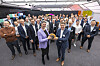 Gruppe von Gästen und Mitarbeitenden bei einem Kundenevent im Covestro Pilot Plant in einer Industriehalle.