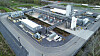 Luftbild einer Industrieanlage mit Tanks, Rohrleitungen und mehreren Gebäuden entlang einer Straße.